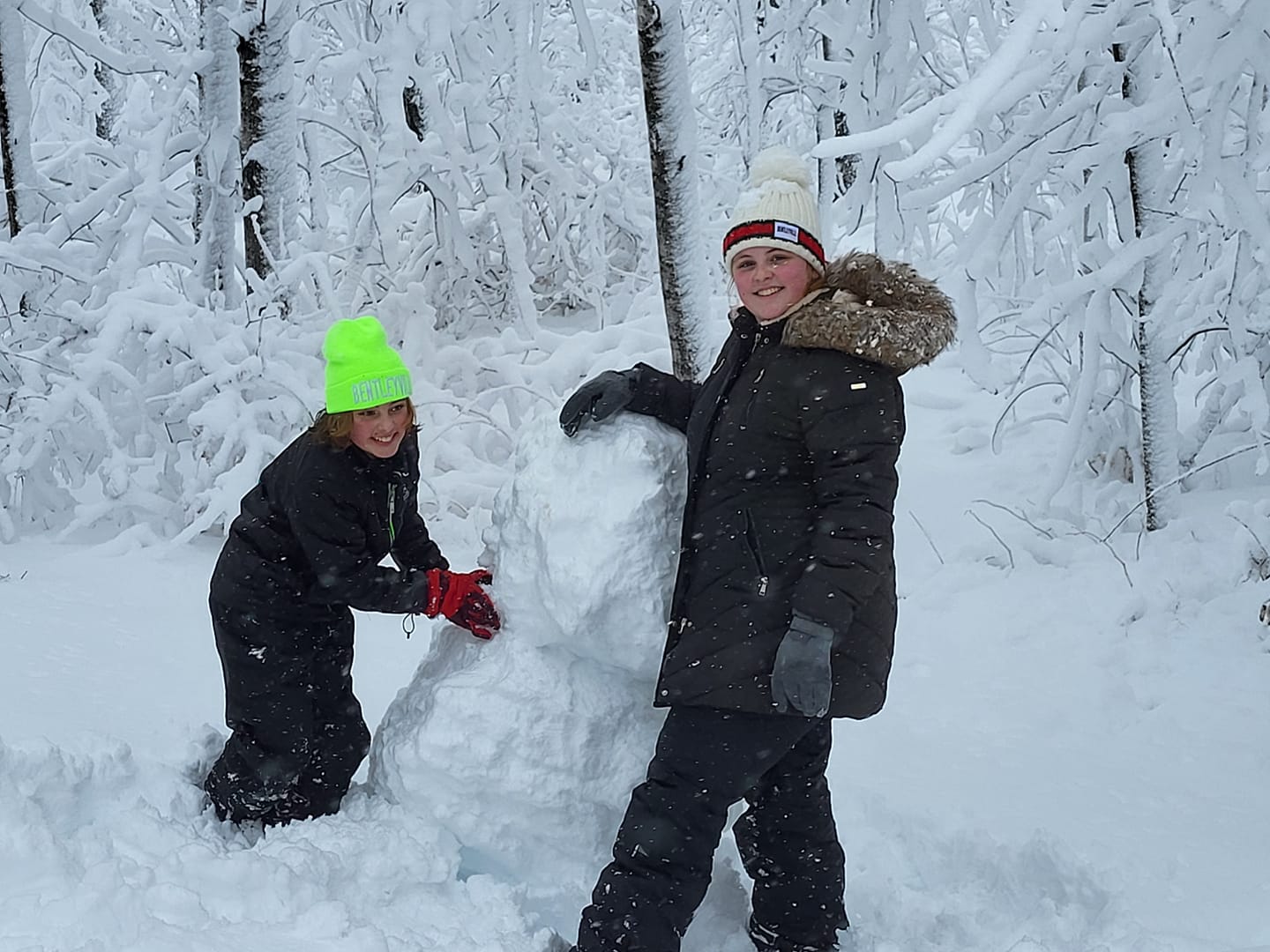 Boys building snowman